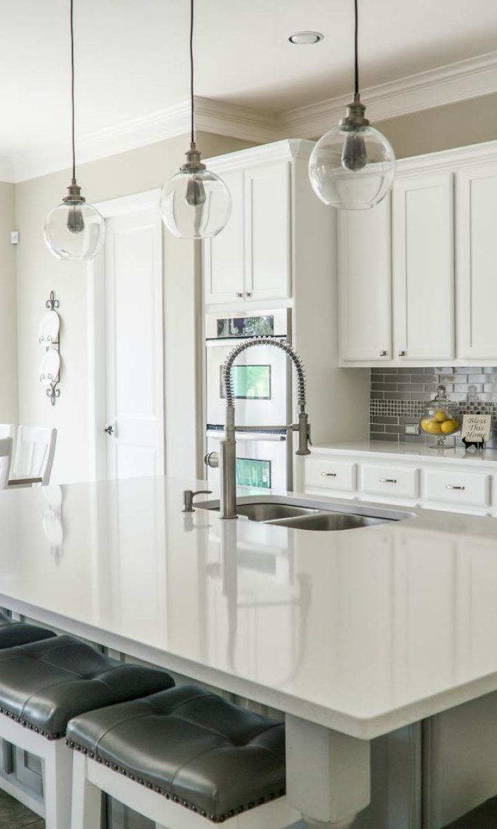 Photo by Mark McCammon Spacious modern kitchen with white cabinets and island in natural light.