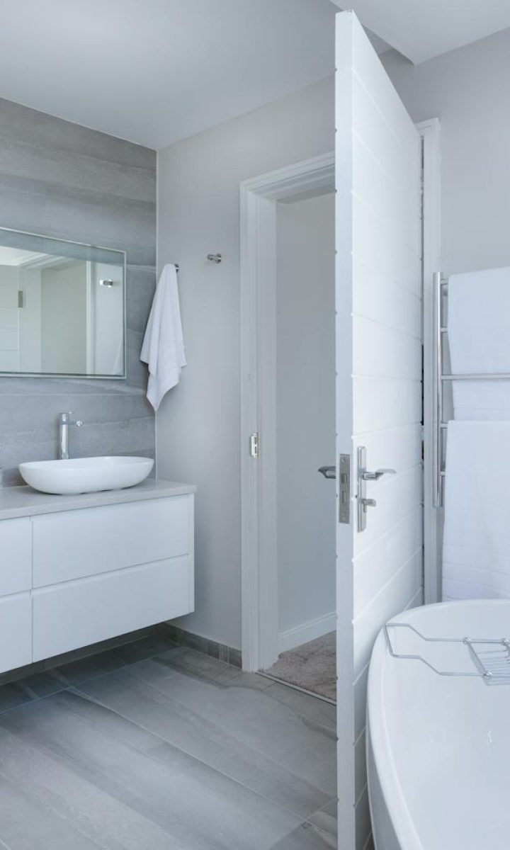 Photo by Jean van der Meulen Sleek contemporary bathroom with bathtub and twin sinks, showcasing minimalist design and luxury.