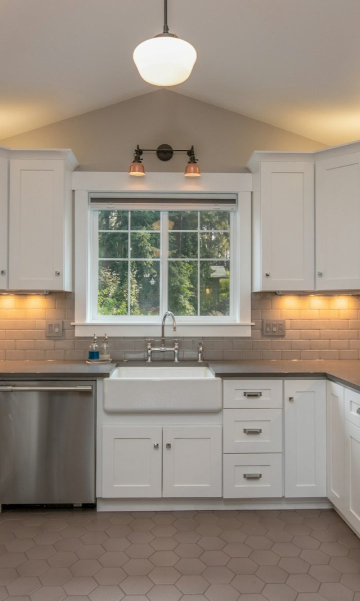 white wooden kitchen cabinet with white pendant lamp