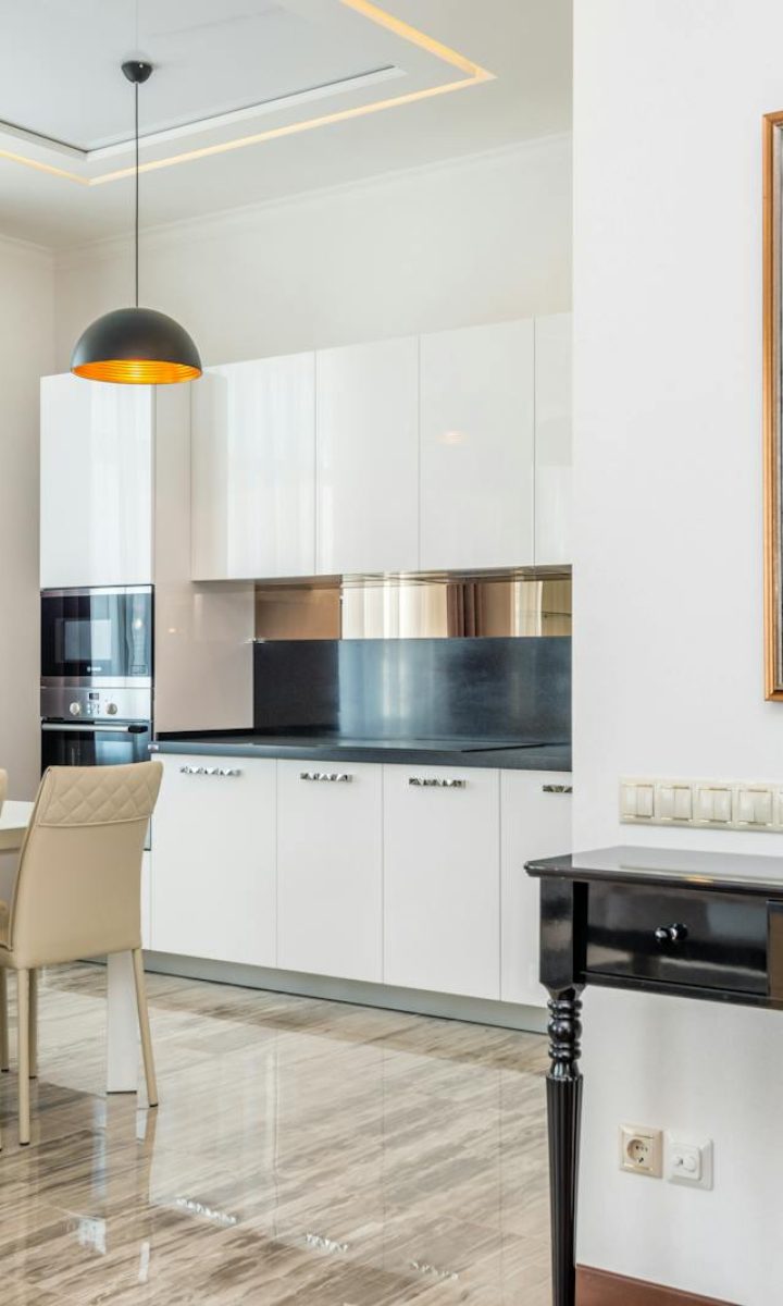 Photo by Max Vakhtbovycn Stylish modern dining room and kitchen with sleek furniture and elegant decor.
