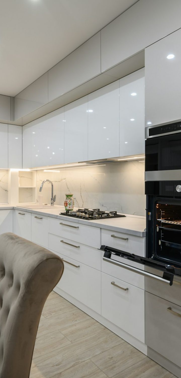 Huge white luxury kitchen in a studio apartment interior