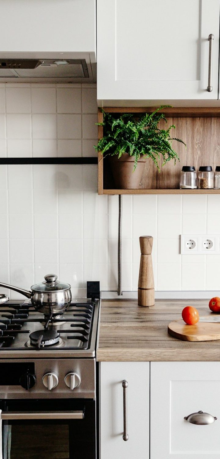 Luxury modern kitchen furniture in grey color and steel oven, sink, wooden tabletop