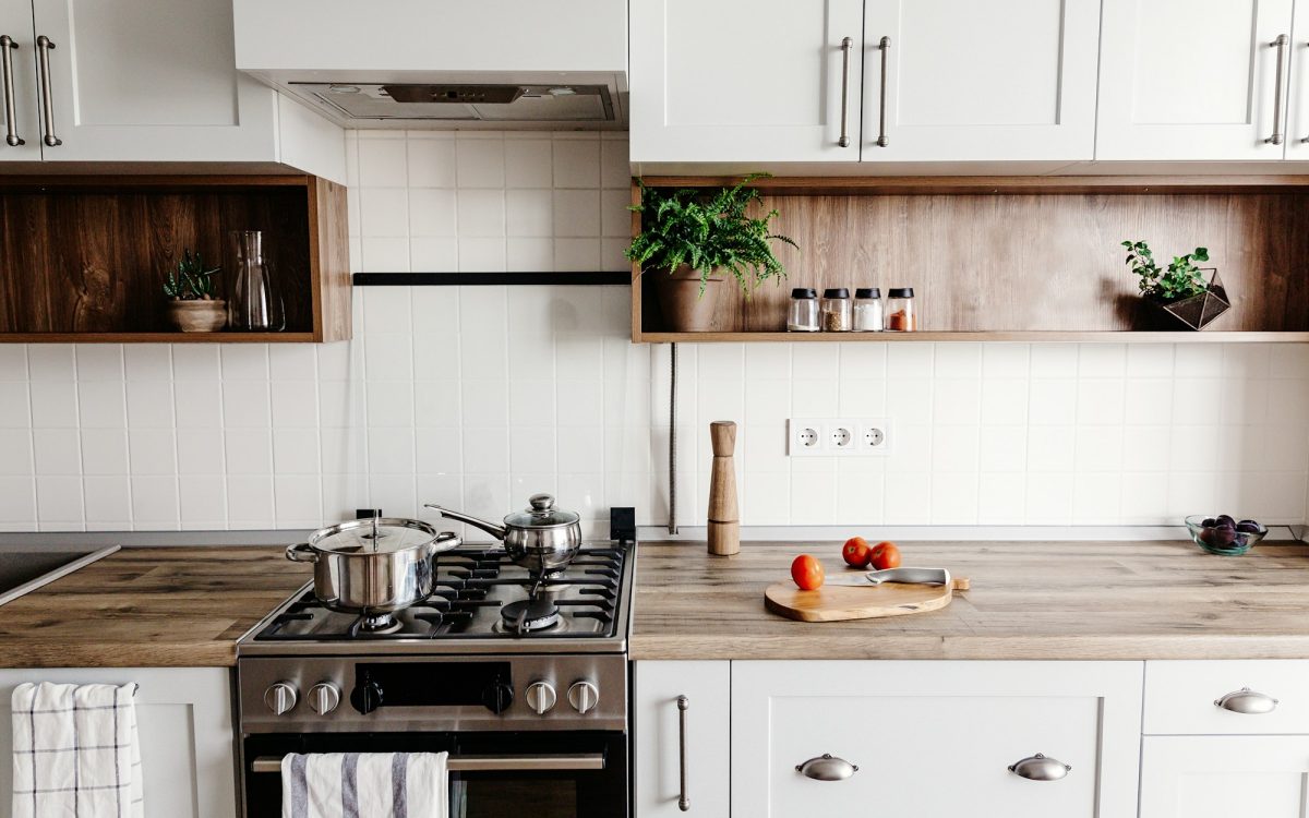 Luxury modern kitchen furniture in grey color and steel oven, sink, wooden tabletop