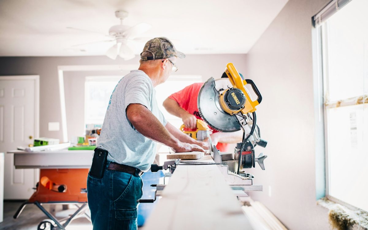 Photo by Annie Gray man standing infront of miter saw